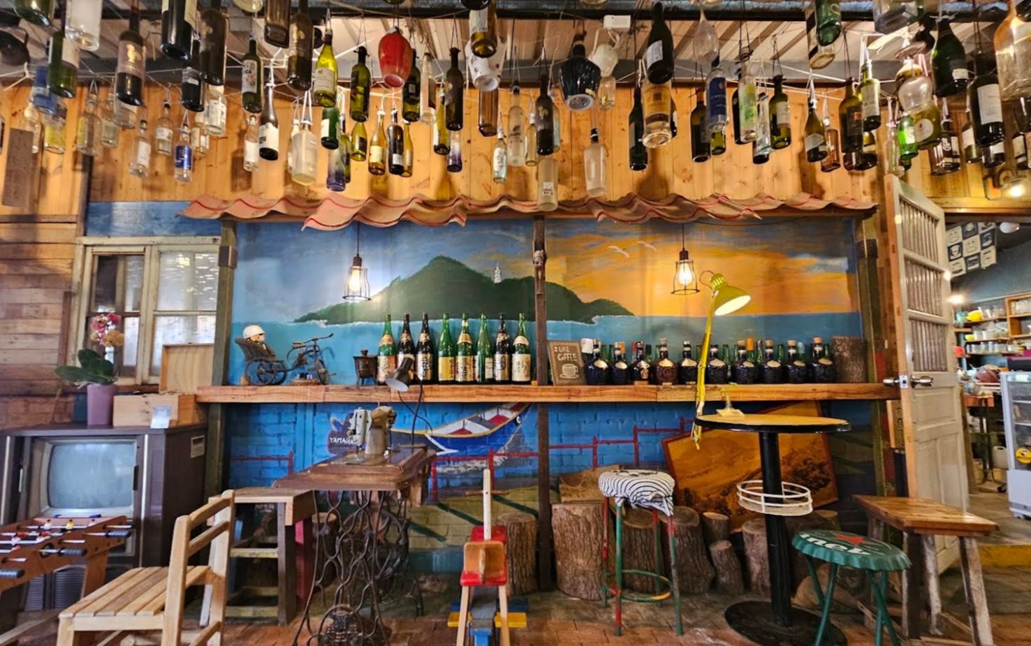 Kamon Café's eclectic bottle room and painted wall